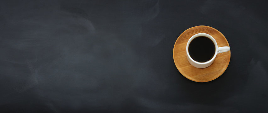 top view image of coffee cup over empty blackboard background