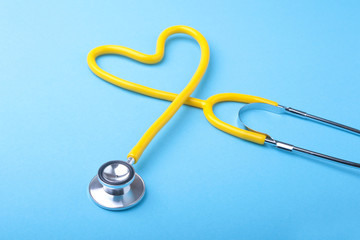 Red heart and a stethoscope on desk