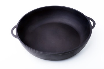 A new, clean and empty cast-iron pan for the grill.
