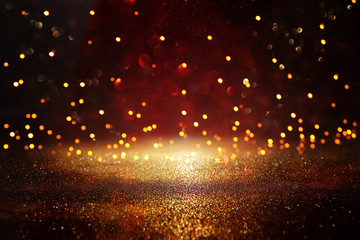 Fototapeta premium Red, black and gold glitter vintage lights background. defocused.