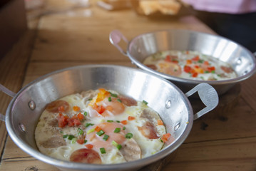 Breakfast Time,Fried Egg in pan with spring onion,carrot,chinese sausage and pork.Thai and Indochina food style.