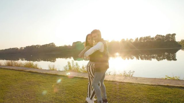 Concept of love and relationships. Young couple dancing at sunset