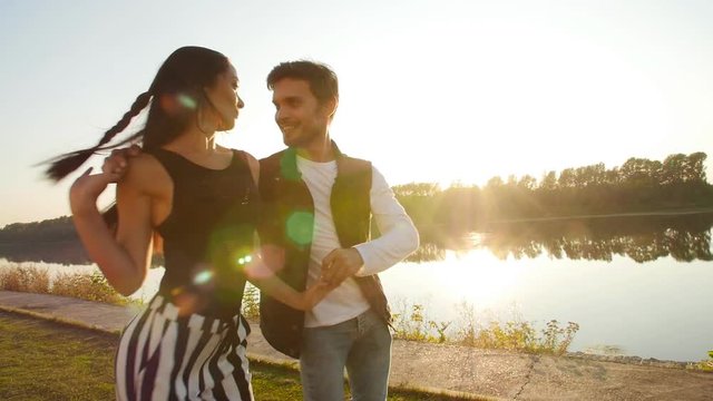Concept of love and relationships. Young couple dancing at sunset