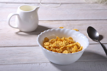 Corn Flakes cereal in a bowl and glass with milk. Morning breakfast.