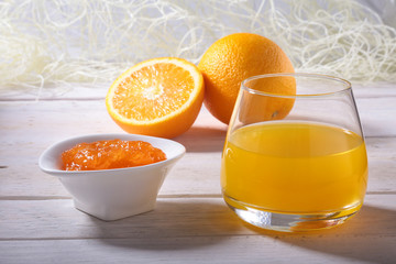 Orange jam and juice in glass. Morning breakfast.