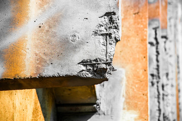 Orange and gray damaged reinforced concrete structure