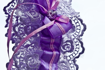Garter of a bride on a white background, close-up