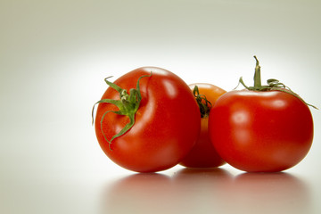 Red tomatoes in white background 