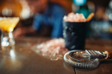 Black glass with ice, cold crystals on bar counter