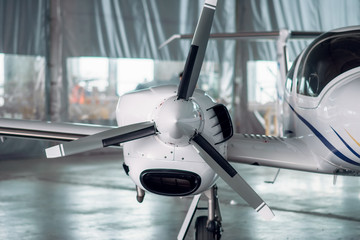 Obraz premium Propeller airplane in hangar, plane on inspection