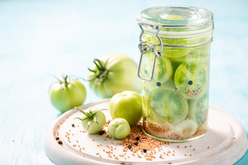Fresh ingredients for pickled green tomatoes in the jar