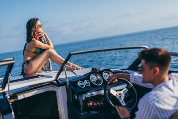 Wealthy successful businessman rent a speed luxury motor boat to take a drive with his new passion-...