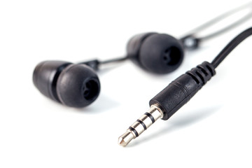 Black headphones on a white background, close up