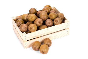 Wooden box filled with many ripe and fresh kiwi fruits and three whole fruits in front of it  isolated on white background