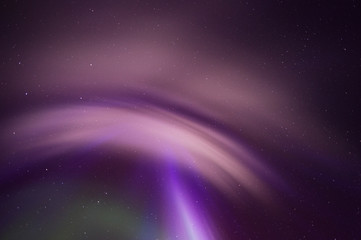 Aurora Borealis corona and stars overhead in the night sky.