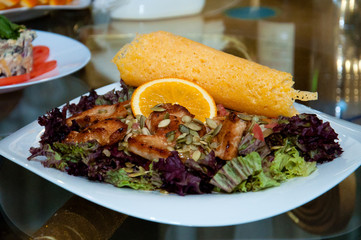 Salad with meat, orange, cabbage, rucola and toast, background, close-up