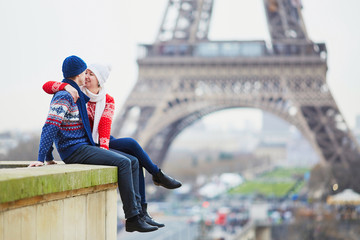 Happy couple near the Eiffel tower on a winter day