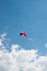 Naklejka na ściany i meble Background colorful balloons flying in the blue sky with clouds