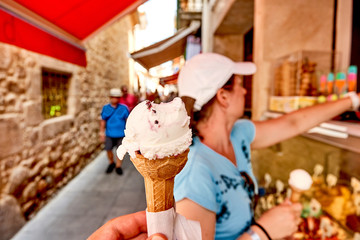 woman buying ice cream in Tossa de Mar, Costa Brava, Catalonia, Spain