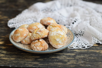 Lemon cookies with cracks with sugar powder on a plate