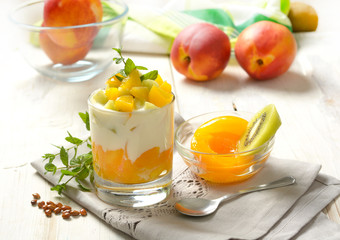 dessert with peaches in syrup, kiwi and yogurt