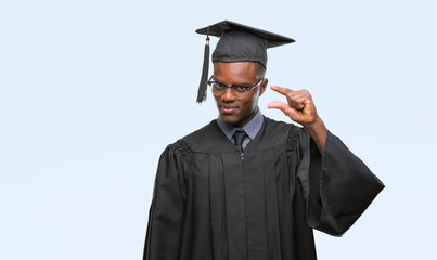 Young graduated african american man over isolated background smiling and confident gesturing with...