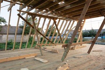 New construction home framing against blue sky at sunser, closeup of ceiling frame.