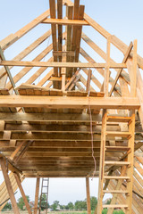 Single Family Home Construction. Building a New Wood Framed House. Wooden rafters against the blue sky at sunset.