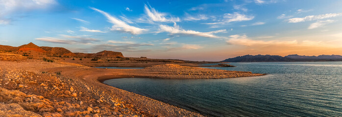 Beautiful panoramic landscape of the Lake Mead National Recreation Area from its muddy shore at sunset in summer, Nevada.