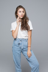 Obraz premium Beautiful young woman in white shirt on grey background