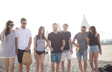 Group Of Friends walking Along Beach Together, having fun, smiling