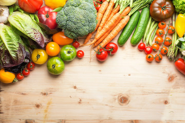 Fresh farm produce, organic vegetables on wooden pine table, healthy background, copy space for text on the bottom, top view, selective focus