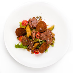 meat salad with roast beef, croutons, vegetables and potatoes on white background, isolated.