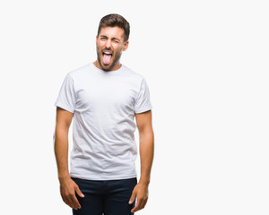 Young handsome man over isolated background sticking tongue out happy with funny expression. Emotion concept.
