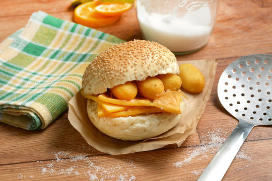 sandwich with panelle - traditional street food of Sicily - made with chickpea flour