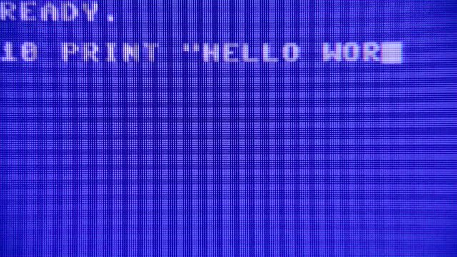 Writing a simple Hello World program on a retro vintage computer, listing and running it. Macro detail screen.
