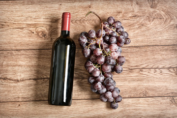 bottle of red wine and bunch of grapes