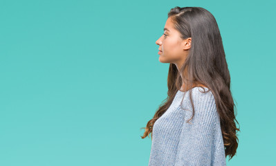 Young beautiful arab woman wearing winter sweater over isolated background looking to side, relax profile pose with natural face with confident smile.