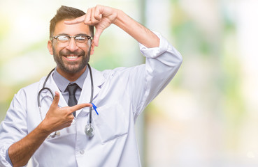 Adult hispanic doctor man over isolated background smiling making frame with hands and fingers with happy face. Creativity and photography concept.