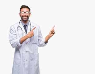 Adult hispanic doctor man over isolated background smiling and looking at the camera pointing with two hands and fingers to the side.