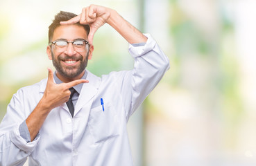 Adult hispanic scientist or doctor man wearing white coat over isolated background smiling making frame with hands and fingers with happy face. Creativity and photography concept.