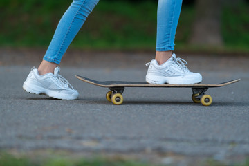 Young woman pushing herself on a skateboard