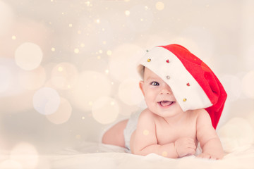 Beautiful little baby celebrates Christmas New Year's holidays Baby red hat boken background