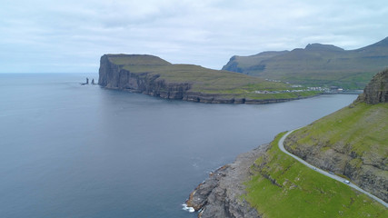 AERIAL: Flying over the calm ocean and towards spectacular cliffs and village.