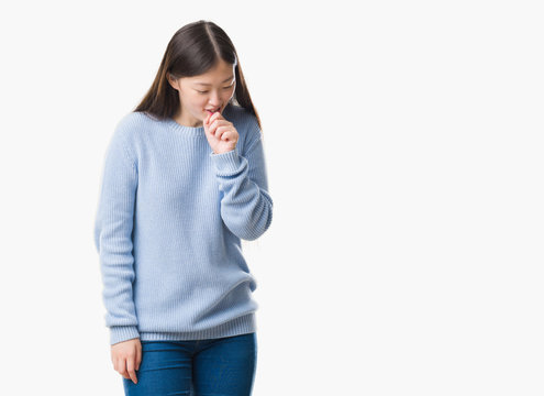 Young Chinese woman over isolated background feeling unwell and coughing as symptom for cold or bronchitis. Healthcare concept.