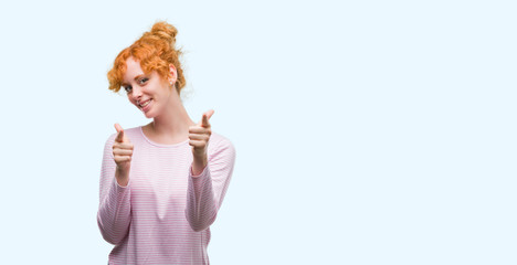 Young redhead woman pointing fingers to camera with happy and funny face. Good energy and vibes.