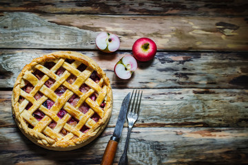 Homemade fruit pie on wooden table.