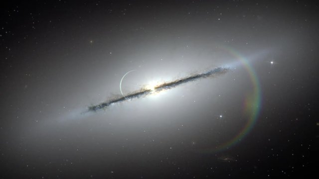 Sombrero galaxy rotating over star field, flare light at center. Contain public domain image by NASA