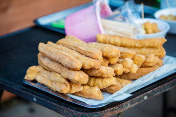 Delicious Asia, Asian eating food. Frying mini Chinese Churros or Chinese Donut with soy milk for breakfast menu. ( Thai name is Patongko ). Chinese Doughnuts Popular breakfast served with soy milk.