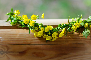 Wreath of wild flowers on the wood